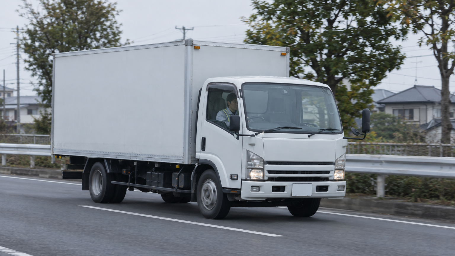 朝の幹線道路を走る4tトラック